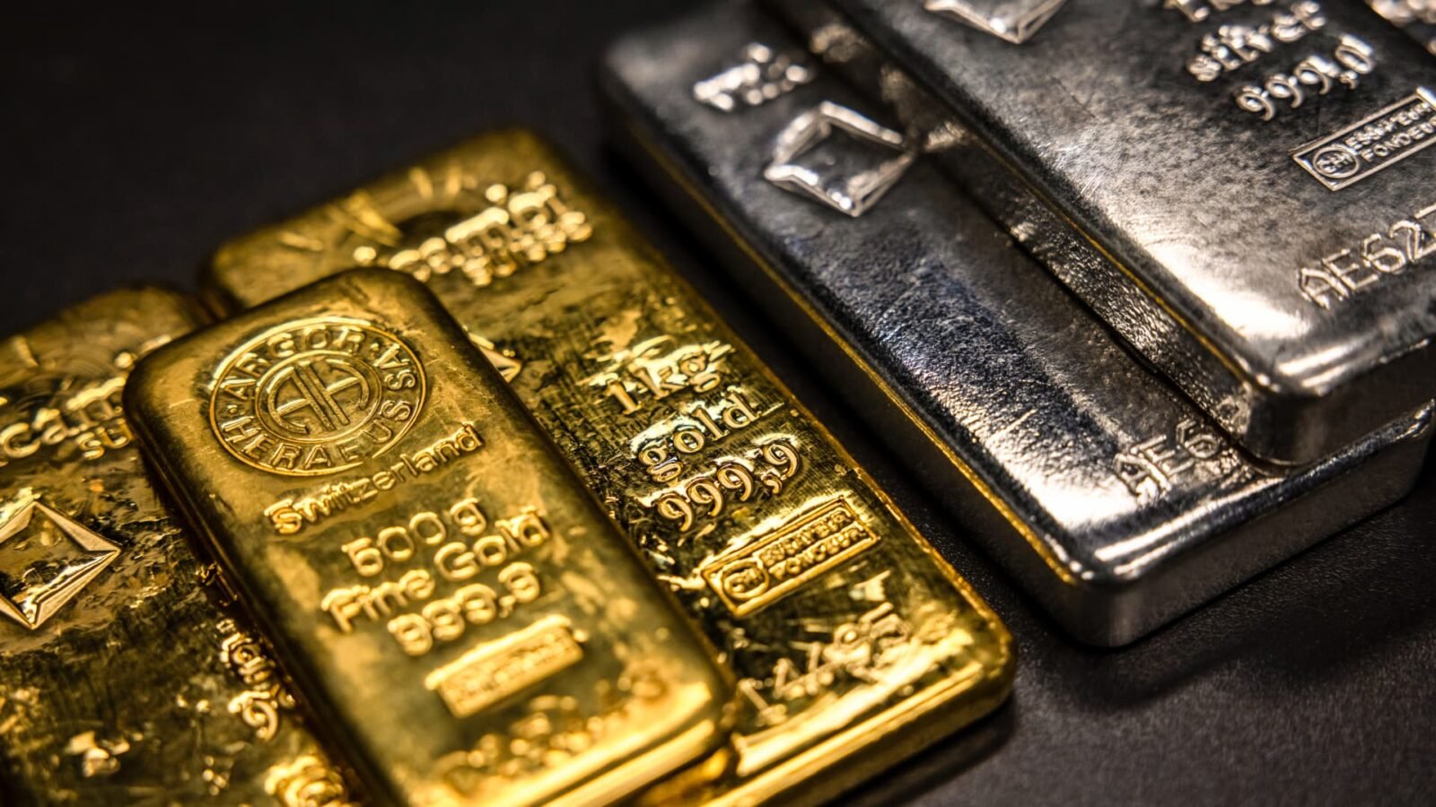 One kilogram and five hundred gram gold bars alongside one kilogram silver bars at a dealer in Barcelona, Spain.