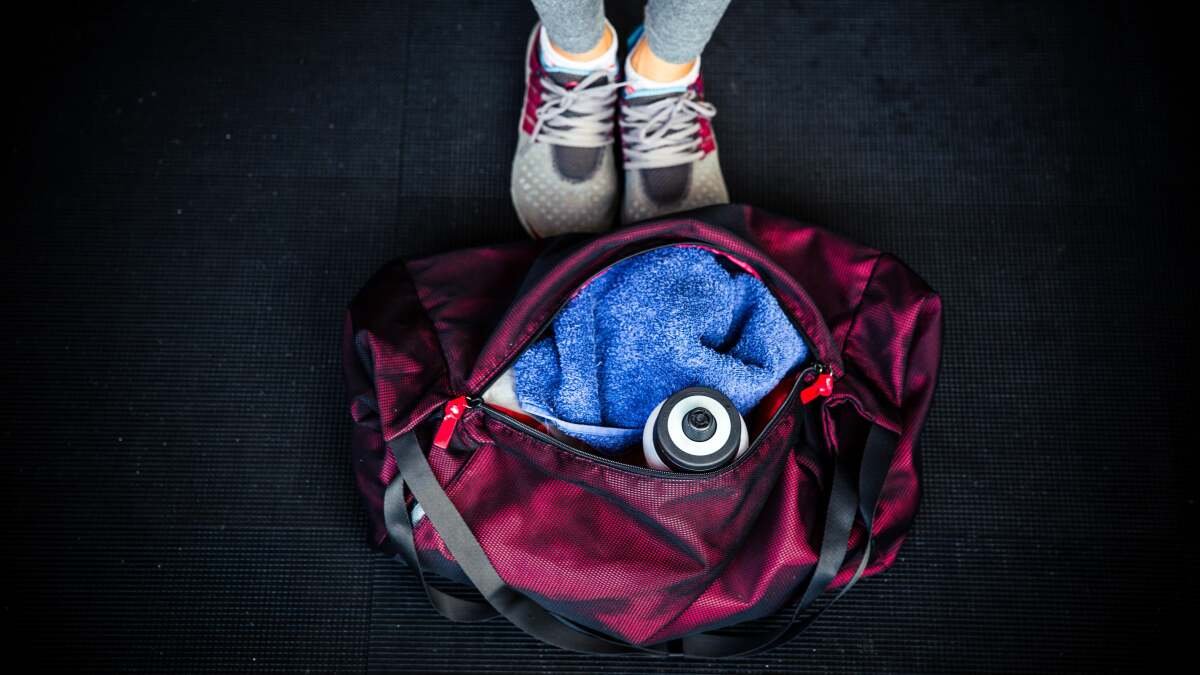 A clean, fresh gym bag with neatly folded workout clothes and shoes, free from odor.
