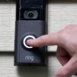 Privacy Pushback: Amazon's Ring Dumps Surveillance Partner After Public Outcry 4 Amazon Ring doorbell camera with Flock Safety logo in the background, symbolizing the terminated partnership and public privacy concerns.