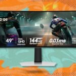 A large, curved Samsung Odyssey OLED G9 gaming monitor displaying vibrant game graphics.