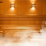 Saunas: Your Guide to Real Benefits and Debunked Myths 2 A person relaxing in a traditional wooden sauna, surrounded by steam and warmth.