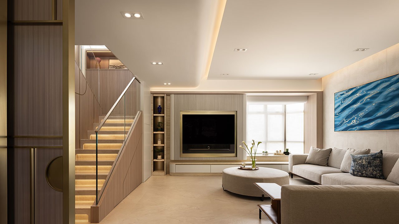 Interior view of a modern Hong Kong duplex living space with curved walls, textured surfaces, and sculptural lighting, overlooking Repulse Bay.