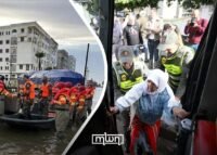 Residents returning to their homes in Sidi Kacem after flood evacuations, with damaged infrastructure in the background.