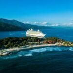 Set Sail Solo: Discover the Best Cruises for Independent Travelers 4 A cruise ship sailing on the open ocean at sunset, symbolizing solo travel and adventure.