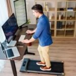 A person walking on a compact treadmill in a modern home setting, illustrating convenience and space-saving design.
