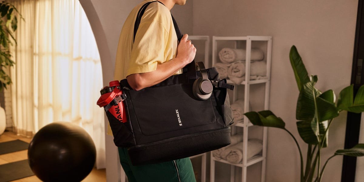 A Stanley Quencher tumbler alongside wellness products like a yoga mat and water bottle, symbolizing the brand's expansion into the health and wellness market.