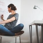 A startup team collaborating, with graphs and data visualizations in the background, symbolizing market analysis and strategic pivoting.