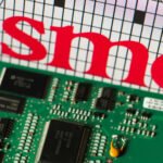 Taiwan Semiconductor Manufacturing Company (TSMC) logo next to a printed circuit board, symbolizing the island's critical role in global chip production.