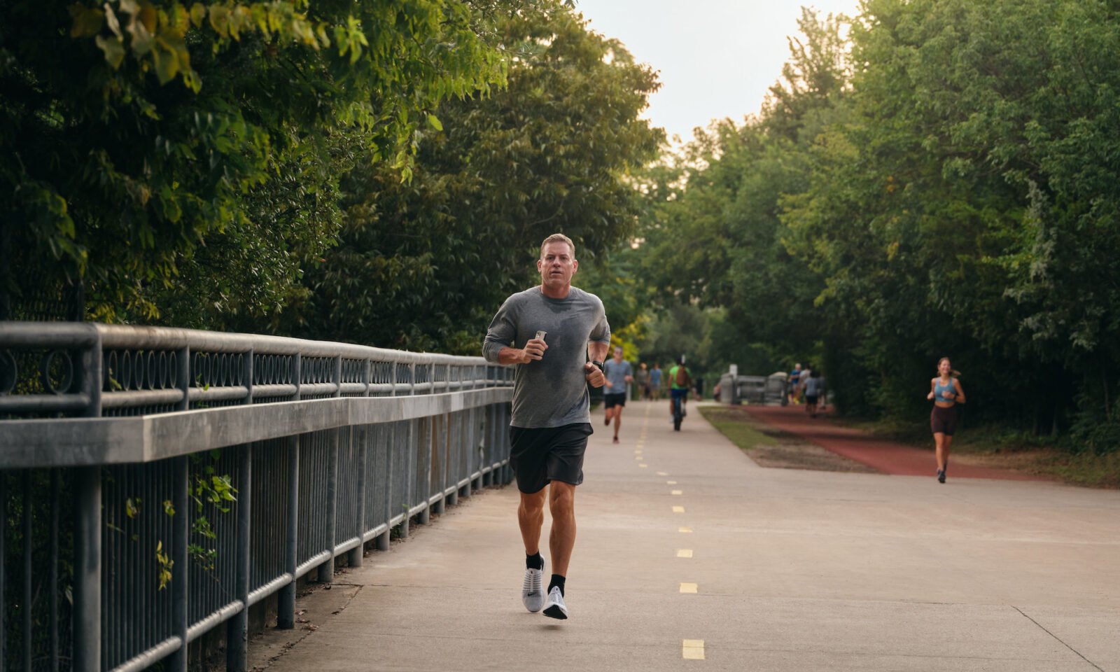 Troy Aikman, former NFL quarterback and current broadcaster, smiling and looking healthy, representing his commitment to wellness.