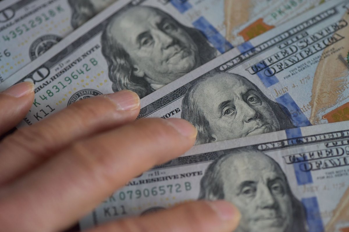 The Dollar's Shifting Fortunes: Decoding Trump's Currency Stance 3 President Donald Trump speaking at an economic event, with financial charts or currency symbols in the background.