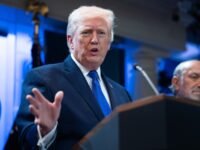 US President Donald Trump speaking at a podium, announcing new trade policies.