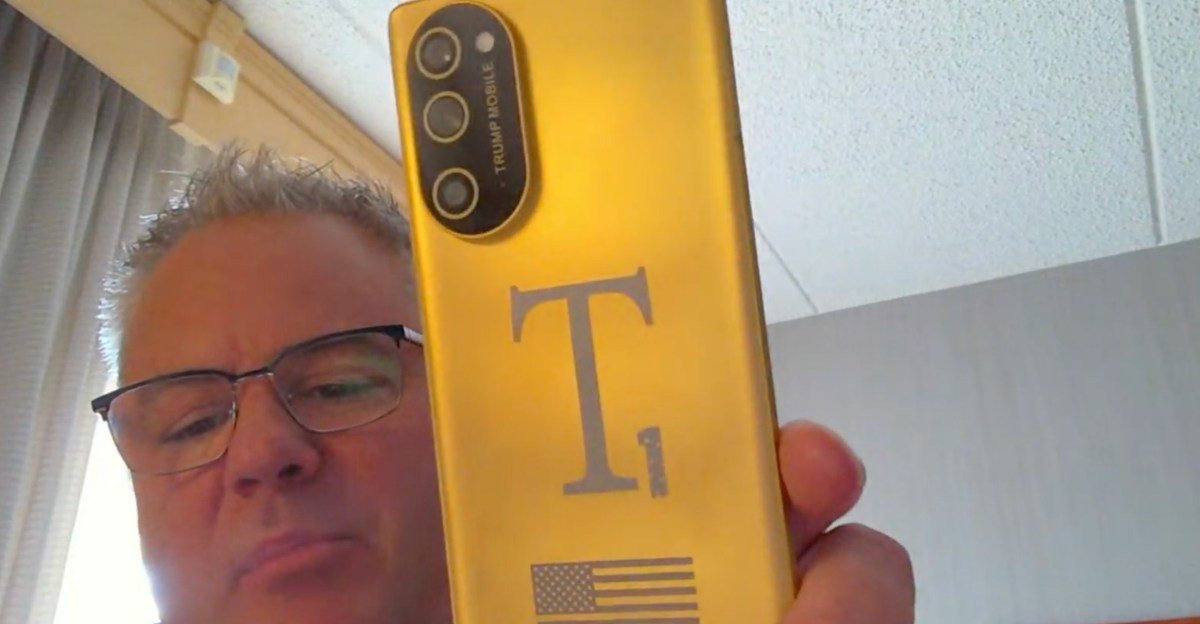 Exclusive: Inside the Evolving Saga of the Trump Mobile T1 Phone 3 A render or screenshot of the Trump Mobile T1 Phone, featuring its gold finish and redesigned vertical camera island.