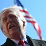 Former President Donald Trump walks to board Marine One, facing political challenges.