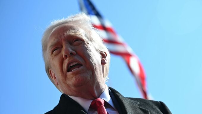 Former President Donald Trump walks to board Marine One, facing political challenges.