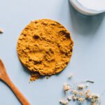 Golden turmeric root and powder, symbolizing natural relief for PMS symptoms.