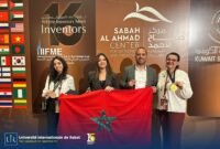 International University of Rabat (UIR) representatives proudly displaying Gold and Bronze medals at an innovation fair.