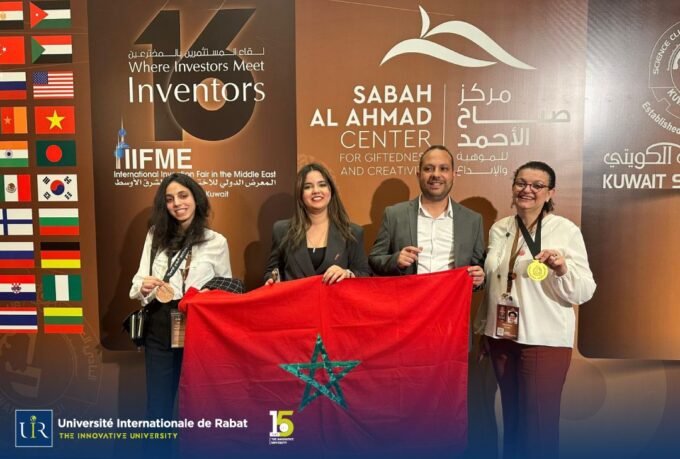 International University of Rabat (UIR) representatives proudly displaying Gold and Bronze medals at an innovation fair.
