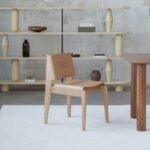 Undia chair by TAMO, showcasing its wave-inspired design and oak finish.