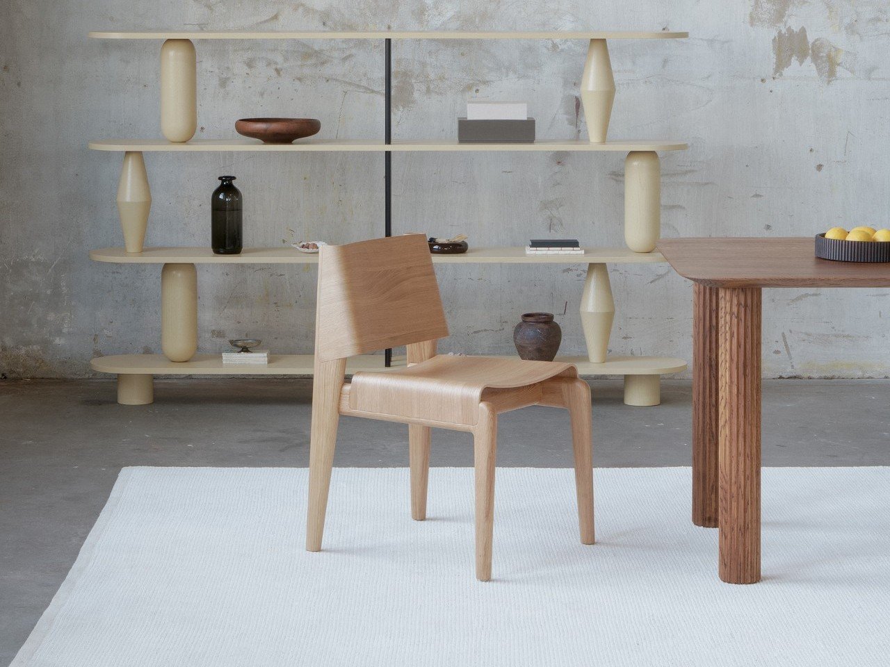 Undia chair by TAMO, showcasing its wave-inspired design and oak finish.