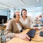 Older person working on a laptop, symbolizing unretirement due to financial necessity.