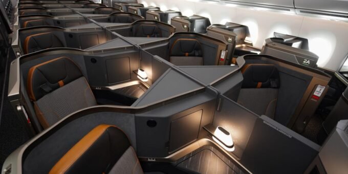 Modern, luxurious business class cabin interior with lie-flat seats on a new aircraft flying US-Asia routes