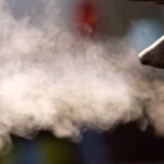 Climate Crossroads: Trump's Sweeping Repeal of US Greenhouse Gas Regulations 4 Exhaust fumes billowing from a car tailpipe in San Francisco, symbolizing vehicle emissions.