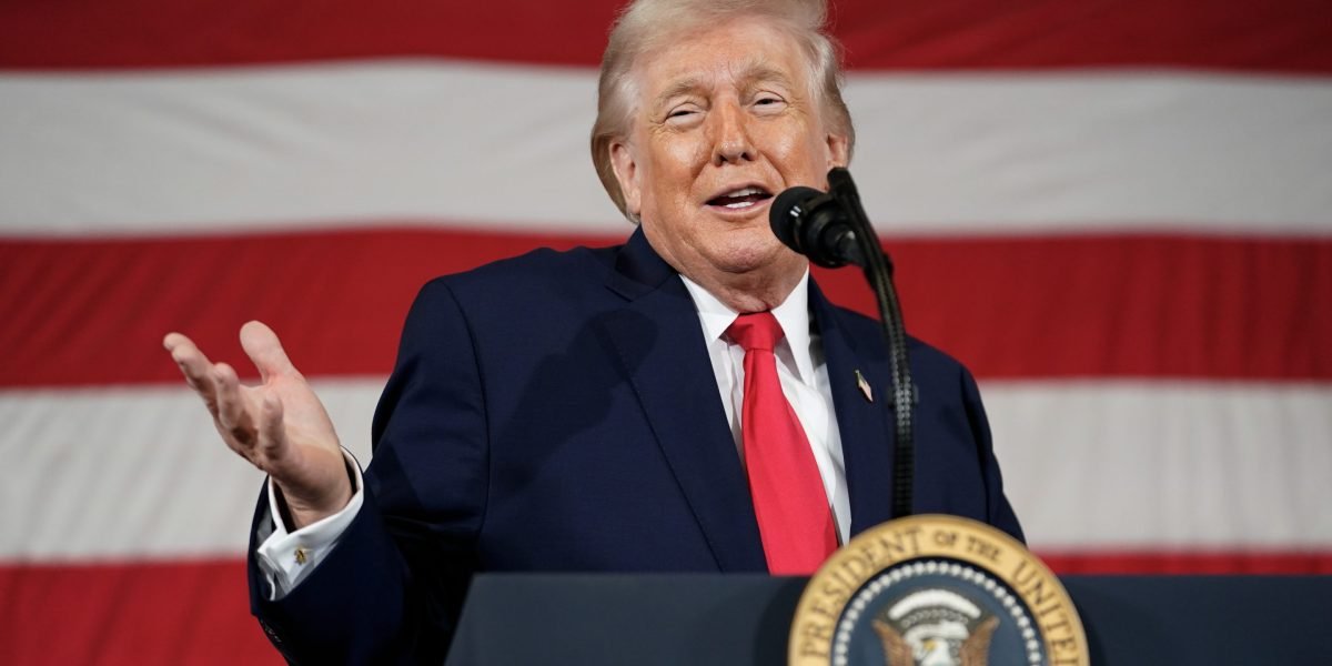 President Donald Trump signing an executive order on trade, with a globe icon in the background, symbolizing global tariffs.