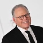 Warner Bros. Discovery logo with streaming icons and stock tickers representing Netflix and Paramount