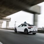 Waymo autonomous vehicle operating on a city street, symbolizing the future of robotaxi services.