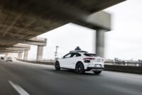 Waymo autonomous vehicle operating on a city street, symbolizing the future of robotaxi services.