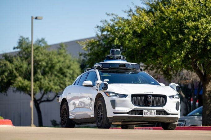 A Waymo autonomous vehicle, a driverless robotaxi, operating on a street in Nashville
