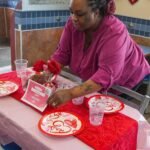 From Sliders to Sweethearts: White Castle's 35-Year Valentine's Day Love Affair 2 A White Castle restaurant dining room transformed for Valentine's Day with candles, white tablecloths, and festive decorations.
