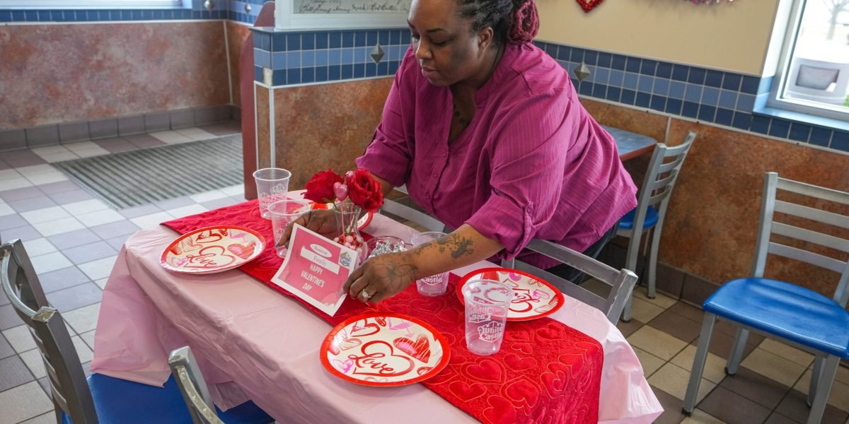 A White Castle restaurant dining room transformed for Valentine's Day with candles, white tablecloths, and festive decorations.