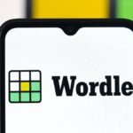 A person playing the Wordle game on a smartphone, illustrating the popular daily word puzzle.