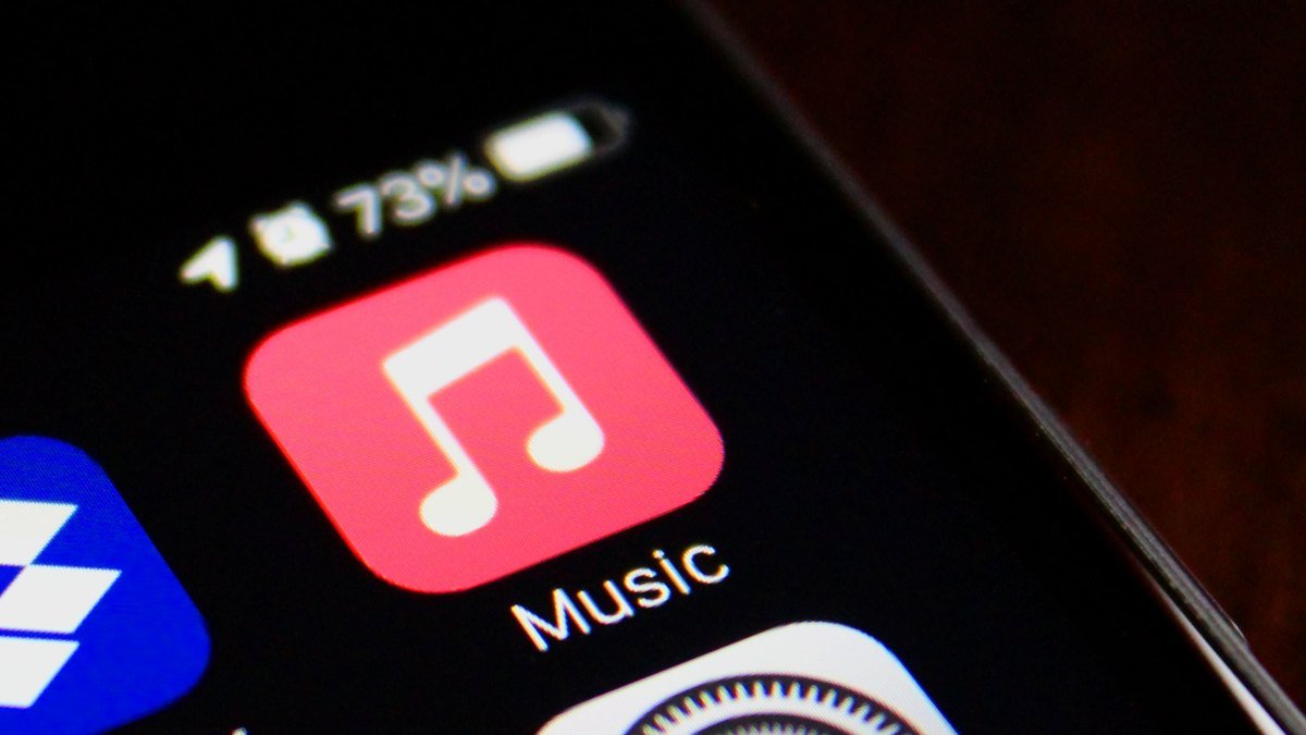 Decoding AI: Apple Music Introduces Transparency Tags for Music Content 3 Apple Music logo with AI-related graphics, symbolizing transparency in AI-generated music content.