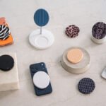 ALMA magnetic portable charger with a stylish snakeskin cover attached to a smartphone, showcasing its sleek design.