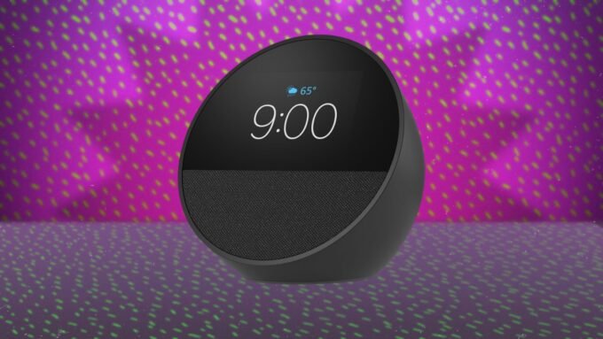 Amazon Echo Spot smart alarm clock displaying time and weather on a bedside table.