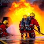 A diverse group of workers including a firefighter, construction worker, and nurse, looking determined in their respective work environments.