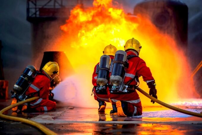 A diverse group of workers including a firefighter, construction worker, and nurse, looking determined in their respective work environments.