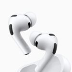 Person wearing AirPods, with a visual representation of real-time language translation appearing between two people speaking different languages.