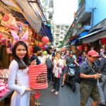 Person using Babbel language learning app on a tablet, with a world map in the background.