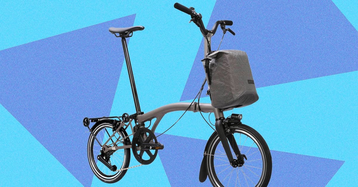 The Brompton Electric T-Line: Redefining Portable Power on Two Wheels 3 Brompton Electric T-Line folding bicycle in titanium, showcasing its compact design and electric features.