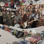 Blues Royalty Meets Hollywood: Buddy Guy and Miles Caton Ignite NPR's Tiny Desk 2 Buddy Guy and Miles Caton perform on stage with guitars at NPR's Tiny Desk Concert.