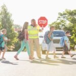 Christine Tyler Hill, a school crossing guard, holding one of her handwritten and illustrated mail club magazines.