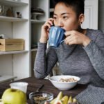 A steaming cup of coffee with a subtle heart graphic or a stethoscope, symbolizing the connection between coffee and heart health.