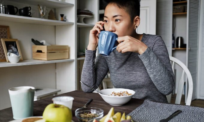 A steaming cup of coffee with a subtle heart graphic or a stethoscope, symbolizing the connection between coffee and heart health.
