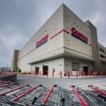 A busy Costco warehouse store with shoppers and bulk products, symbolizing its strong retail performance.