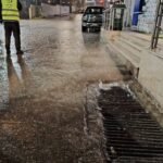 صورة لكوادر بلدية جرش وهي تعمل على معالجة تجمع مياه الأمطار في أحد شوارع المدينة.