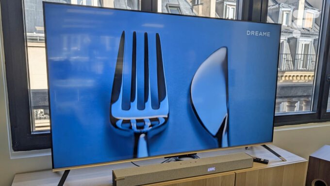 Le téléviseur Dreame 65Q100, un modèle QLED 4K élégant avec des bords fins et un pied doré, présenté de face.