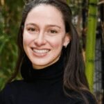 An abstract representation of AI interacting with the physical world, possibly showing a robot hand manipulating objects in a complex simulated environment.